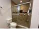 This remodeled bathroom features a tiled shower with a glass door and updated fixtures at 3000 Tangerine Ter, Palm Harbor, FL 34684
