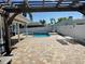 Backyard with a refreshing swimming pool, lounge chairs, and white privacy fence at 3000 Tangerine Ter, Palm Harbor, FL 34684