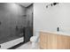 Modern bathroom features tiled glass shower, wood vanity and marble countertop at 3020 W Helen Ave, Tampa, FL 33611