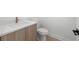 Modern bathroom with quartz countertop, wood cabinets and gold faucet at 3020 W Helen Ave, Tampa, FL 33611
