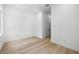 Bright bedroom featuring hardwood floors and access to other rooms at 3020 W Helen Ave, Tampa, FL 33611