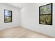 Bright bedroom featuring hardwood floors and ample natural light from windows at 3020 W Helen Ave, Tampa, FL 33611