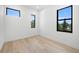 Bright bedroom featuring hardwood floors and ample natural light from multiple windows at 3020 W Helen Ave, Tampa, FL 33611