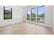 Bedroom with large windows offering serene views of nature at 3020 W Helen Ave, Tampa, FL 33611