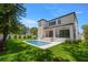 Back exterior view of property featuring a pool, backyard, upper and lower patios at 3020 W Helen Ave, Tampa, FL 33611