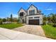 Beautiful two-story home features modern design, brick accents, a paved driveway, and a well-kept lawn at 3020 W Helen Ave, Tampa, FL 33611