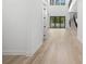 Hallway features hardwood flooring, open space and natural light at 3020 W Helen Ave, Tampa, FL 33611