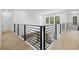 Hallway featuring modern railings with a view down to the pool at 3020 W Helen Ave, Tampa, FL 33611