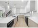 Sleek, modern kitchen with stainless steel appliances, light wood floors, and a quartz countertop at 3020 W Helen Ave, Tampa, FL 33611