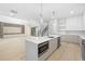 Bright, modern kitchen with quartz counters, stainless appliances, and pendant lighting at 3020 W Helen Ave, Tampa, FL 33611
