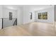 Spacious living area with light wood floors, a modern staircase and three picture windows at 3020 W Helen Ave, Tampa, FL 33611