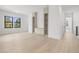 Bright living area with custom built-ins and light wood floors, and three picture windows at 3020 W Helen Ave, Tampa, FL 33611