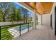 Inviting outdoor patio with a wooden ceiling, fans, railing, and a refreshing pool at 3020 W Helen Ave, Tampa, FL 33611