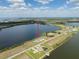 Aerial view of a waterside home featuring a pool and beautiful views under a blue, partly cloudy sky at 3409 Gulf City Rd, Ruskin, FL 33570