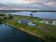 High aerial shot of the rear of a property with a manicured lawn, privacy fence and pool at 3409 Gulf City Rd, Ruskin, FL 33570