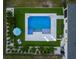 Aerial view of a stunning pool and patio with lounge chairs and an umbrella table at 3409 Gulf City Rd, Ruskin, FL 33570