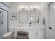 Bathroom boasts double sinks, framed mirrors, vanity area, and an enclosed shower with a beach theme at 3409 Gulf City Rd, Ruskin, FL 33570