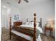 Bright bedroom featuring hardwood floors, four-poster bed and a wooden dresser at 3409 Gulf City Rd, Ruskin, FL 33570
