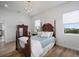 Bright bedroom features a wooden frame bed, matching dresser, and a stylish chandelier at 3409 Gulf City Rd, Ruskin, FL 33570