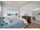Bright bedroom featuring hardwood floors, four-poster bed and an ensuite bathroom at 3409 Gulf City Rd, Ruskin, FL 33570