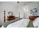 Bright bedroom featuring hardwood floors, four-poster bed and a wooden dresser at 3409 Gulf City Rd, Ruskin, FL 33570