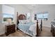 Bright bedroom featuring hardwood floors, four-poster bed and lots of natural light at 3409 Gulf City Rd, Ruskin, FL 33570