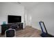 This room features a large TV, console, workout equipment, and sleek wood-look flooring at 3409 Gulf City Rd, Ruskin, FL 33570
