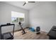 Bright exercise room with a ceiling fan and a variety of workout equipment including a treadmill and stationary bike at 3409 Gulf City Rd, Ruskin, FL 33570