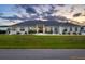 Beautiful exterior view of a modern home featuring a well-manicured lawn and elegant landscaping at dusk at 3409 Gulf City Rd, Ruskin, FL 33570