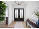 Elegant foyer with wood floors, double doors, designer lighting, and tasteful décor for a sophisticated entrance at 3409 Gulf City Rd, Ruskin, FL 33570