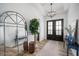 Spacious foyer featuring wood flooring, double doors, stylish lighting, and elegant decorative accents at 3409 Gulf City Rd, Ruskin, FL 33570