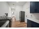 Hallway view into bedroom and laundry room with modern appliances and cabinetry at 3409 Gulf City Rd, Ruskin, FL 33570
