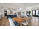 Open-concept kitchen and dining area featuring a large island, white cabinets, and modern lighting fixtures at 3409 Gulf City Rd, Ruskin, FL 33570