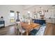 Bright kitchen and dining space with stainless steel appliances, blue island, and water views through the doors at 3409 Gulf City Rd, Ruskin, FL 33570