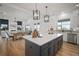 Open-concept kitchen with large island, stainless appliances, and view of the living space at 3409 Gulf City Rd, Ruskin, FL 33570