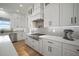 Well-lit kitchen with white cabinets, stainless appliances, and gray subway tile backsplash at 3409 Gulf City Rd, Ruskin, FL 33570