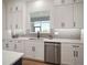 Bright kitchen featuring white cabinets, stainless steel appliances, and modern finishes at 3409 Gulf City Rd, Ruskin, FL 33570