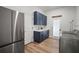 This Laundry room features navy blue cabinets, stainless steel appliances and a white countertop at 3409 Gulf City Rd, Ruskin, FL 33570