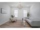 Bright living room featuring wood floors, stylish furnishings, and a modern chandelier at 3409 Gulf City Rd, Ruskin, FL 33570