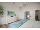 Stylish main bedroom with a dresser, mirror, walk-in closet, and tv at 3409 Gulf City Rd, Ruskin, FL 33570