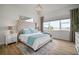 Main bedroom featuring a large headboard, plush bedding, water views and wooden floors at 3409 Gulf City Rd, Ruskin, FL 33570