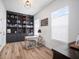 Bright office space with a custom bookcase, ample natural light, and modern furnishings, ideal for productivity at 3409 Gulf City Rd, Ruskin, FL 33570