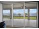 Outdoor patio with sliding glass doors and scenic lake views at 3409 Gulf City Rd, Ruskin, FL 33570