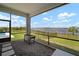 Inviting screened-in patio offering tranquil lake vistas and easy access to the pool at 3409 Gulf City Rd, Ruskin, FL 33570