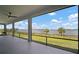 Expansive screened-in patio with scenic lake views and multiple seating areas at 3409 Gulf City Rd, Ruskin, FL 33570