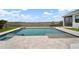Beautiful pool with large patio, water feature, and lake view at 3409 Gulf City Rd, Ruskin, FL 33570