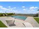 Inviting pool and deck area with lounge chairs and expansive lake view at 3409 Gulf City Rd, Ruskin, FL 33570