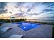 Stunning pool with modern design, underwater lighting, and beautiful lake views, perfect for relaxation at 3409 Gulf City Rd, Ruskin, FL 33570