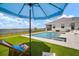 Beautiful pool with large patio, water feature, sun umbrella, and lake view at 3409 Gulf City Rd, Ruskin, FL 33570