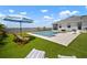 Beautiful pool with large patio, water feature, sun umbrella, and lake view at 3409 Gulf City Rd, Ruskin, FL 33570